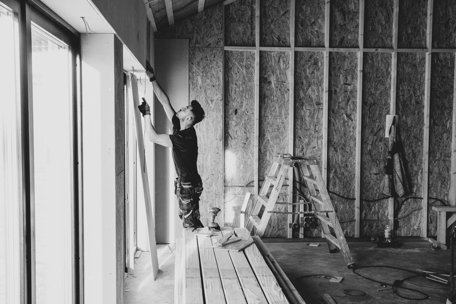 Professional contractor installing a new energy efficient home window